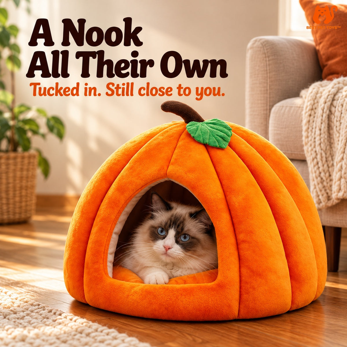 Cat resting in orange pumpkin cave bed