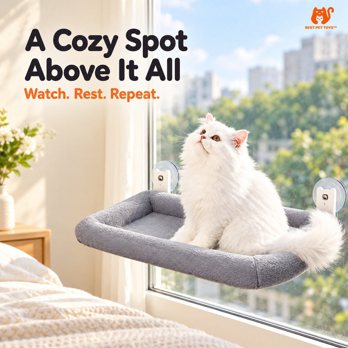 Cat sitting on gray padded window hammock and looking outside