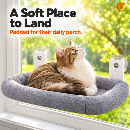 Cat resting on padded gray window hammock